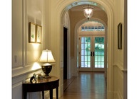 Interior: main hall with raised panel walls and eliptical cased openings 