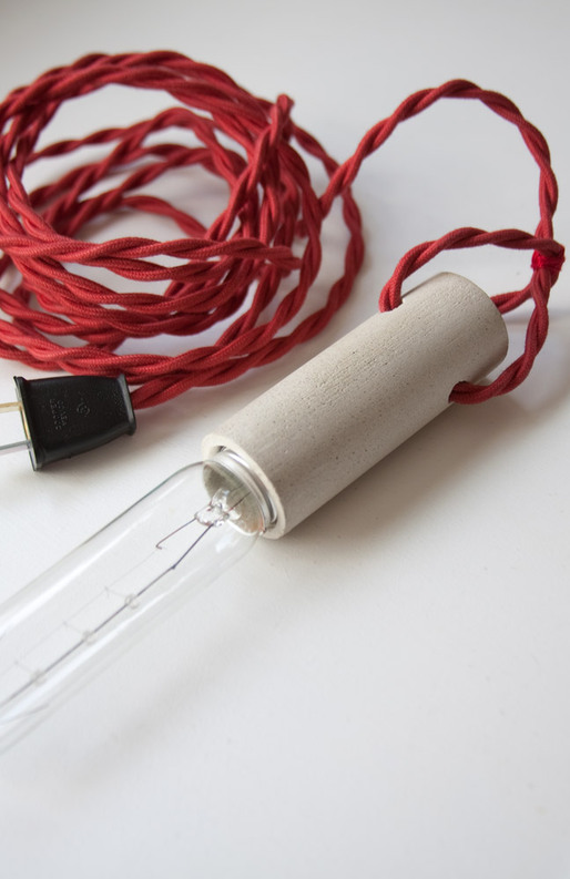 cylinder series – pendant : cast concrete socket with fabric covered wires and T10 light bulb.