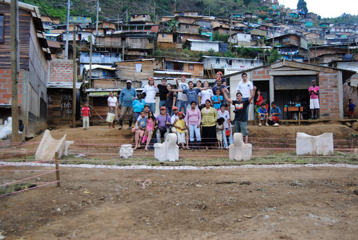 Two residents of barrio Manantiales cooking a big pot of sancocho on the final day of installation