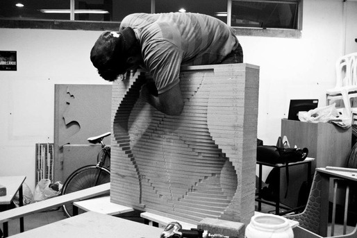 Assembling the top layer of the mold to create the seat and channels for the canicas (marbles).