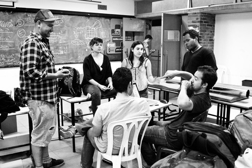 Students having design discussion with James Brazil + Nicholas Waissbluth