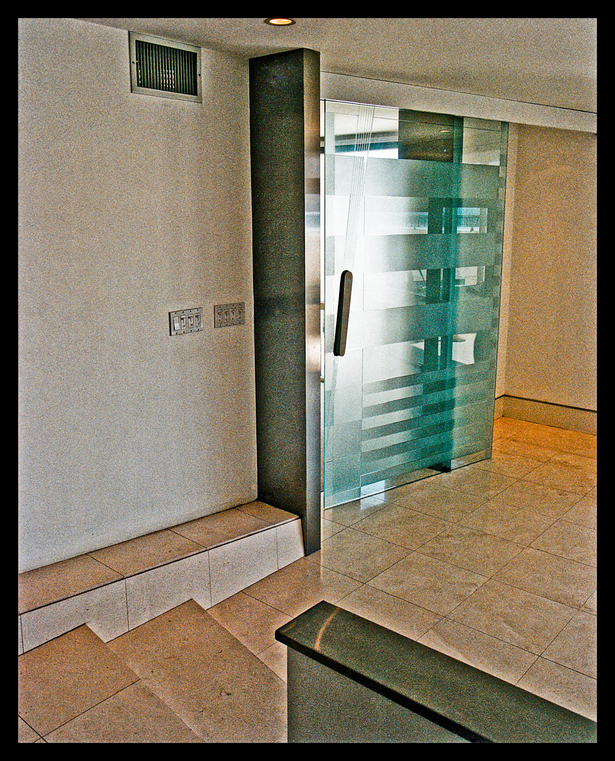 4'x8' suspended blasted glass door entry to master suite. Custom stainless hardware.