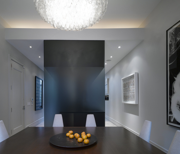 The dining room with glass-enclosed kitchen beyond
