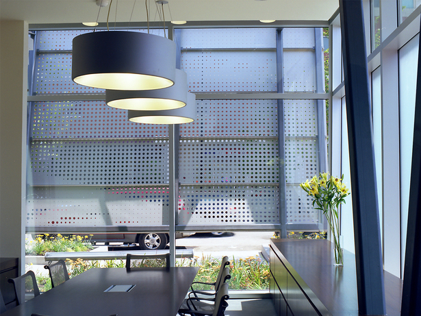 The deposition / conference room is made comfortable with warm, deep brown custom millwork, natural light and continued privacy provided by the street-side screen and translucent frosted windows. (photo by Greg Murphey)
