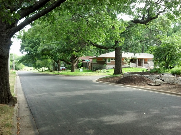 The house defines the corner without dominating the landscape. 