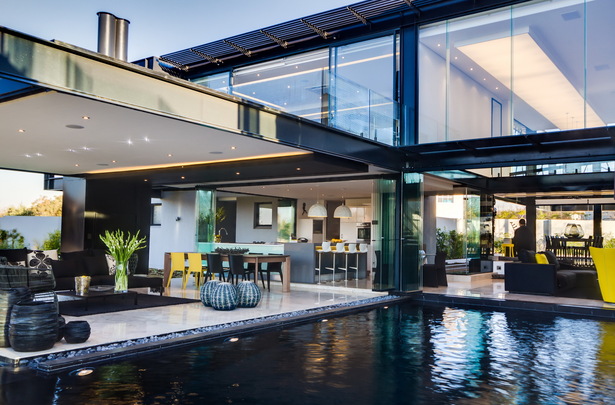 The kitchen frameless windows open up to the lanai and the garden.