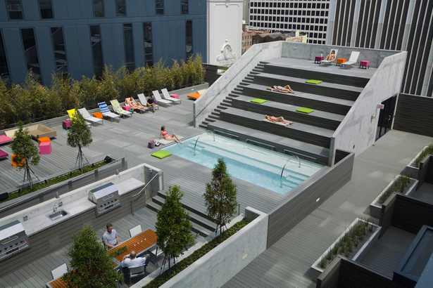 Pool deck and aerial view of townhouses with private decks.