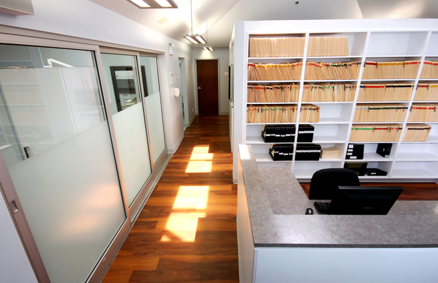 The sliding glass doors leading to the operatories, the sunlight on the corridor floor