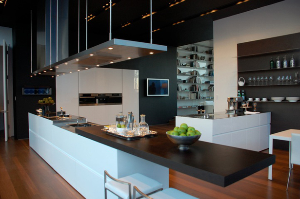 Doors: White Glossy lacquer, 22 mm (3/4”) thick with 30° top edge Sliding Counter: Thermo Oak with electronic movement (counter thickness 8cm = 3 1/8”) Counters: Hand crafted brushed stainless steel, 3 mm (1/8”) thick with soldered sinks and retractable faucet Hood: Custom by Minimal Open Shelving: Thin stainless steel shelving system 6mm (1/4”) thick with Thermo oak back panels