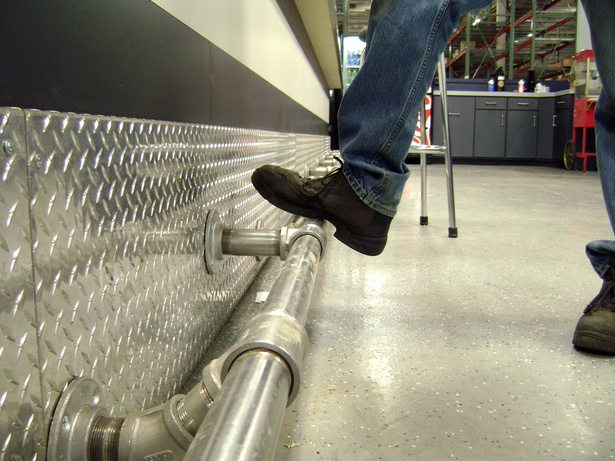  A custom footrail and drawer pulls were made using stainless steel fittings.