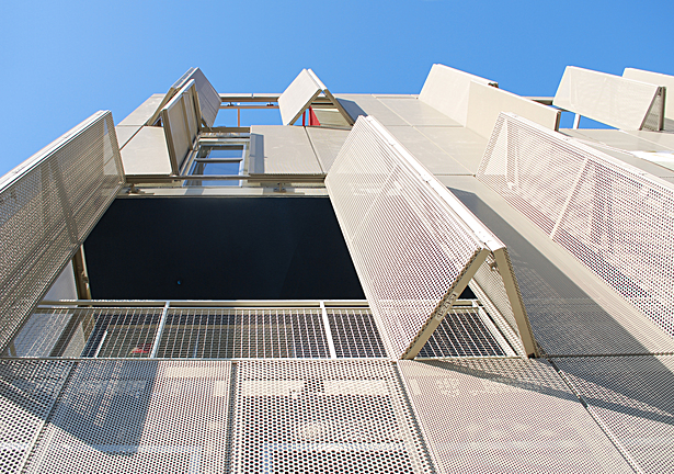 Operable perforated panels at front facade
