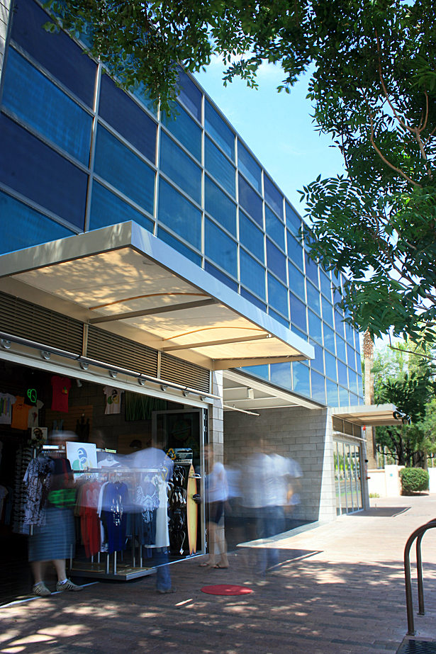 small retail spaces along the street literally open up to engage the sidewalk