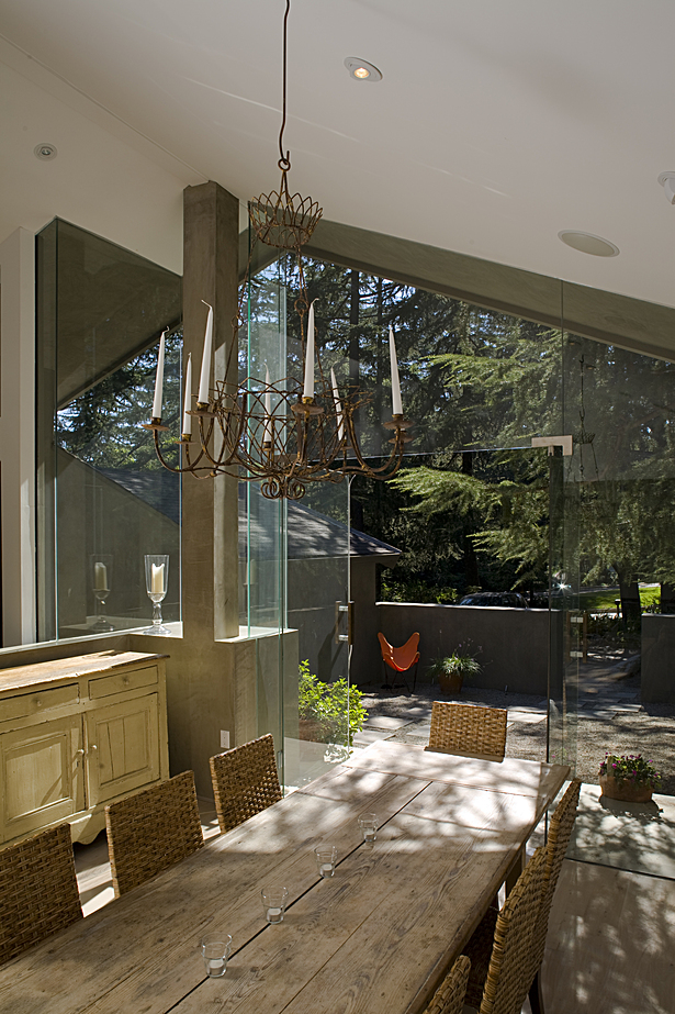 The wall that separated the dining room from the living room space was partially removed to create a visual link all the way from the front entry court, through the house and into the rear yard.