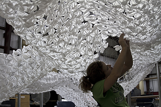 applying pressure-molded flowers to wire mesh skeleton