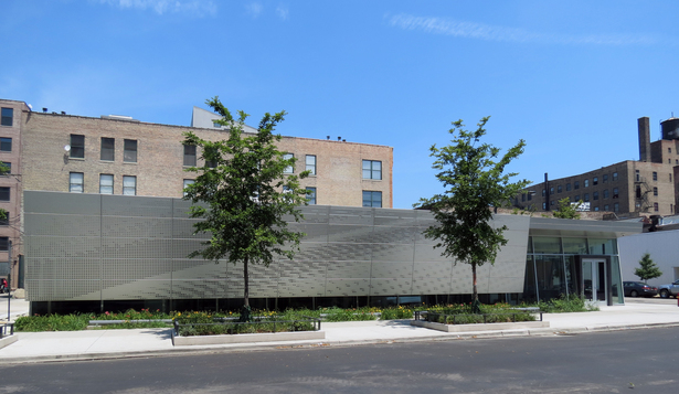 Taking a cue from the history of the site, the Architecture of this law office building is imbued with a sense of American car culture. Similar to the structure of an automobile, sleek, precise lines of material are formed into a distinct exterior tectonic. (photo by R.Benson)