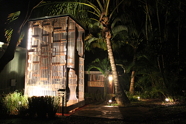 View of the outdoor kitchen with showerhouse behind