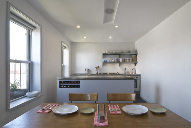With low ceilings, appliances and cabinets are suppressed below the counters to maximize space in the plane of the eye level 