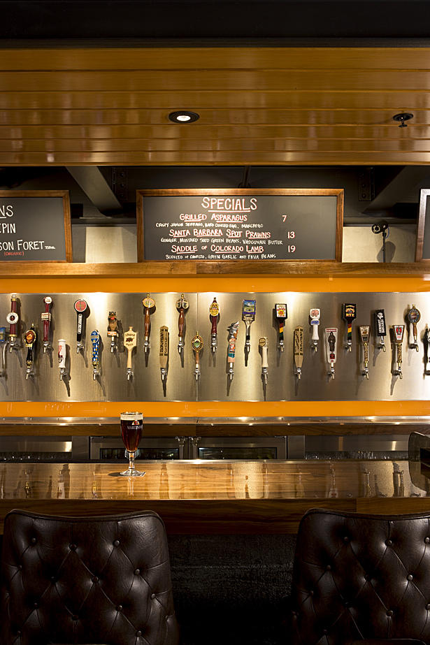 The taps are framed in two glowing amber boxed composed of spectacular wood and a stainless steel face.
