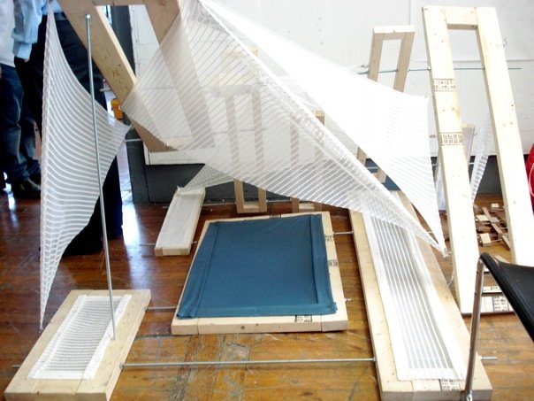 The project kept in mind the movement of the body with joints and bones. From there the form was created that allowed a person to lay within and be enveloped by the fabric and wooden pieces.