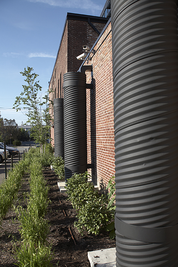 Where storm water does flow off the green roof, the three collection tanks on the west side collect up to 240 cubic feet of the flow. The water is then reused for irrigation and outdoor purposes.