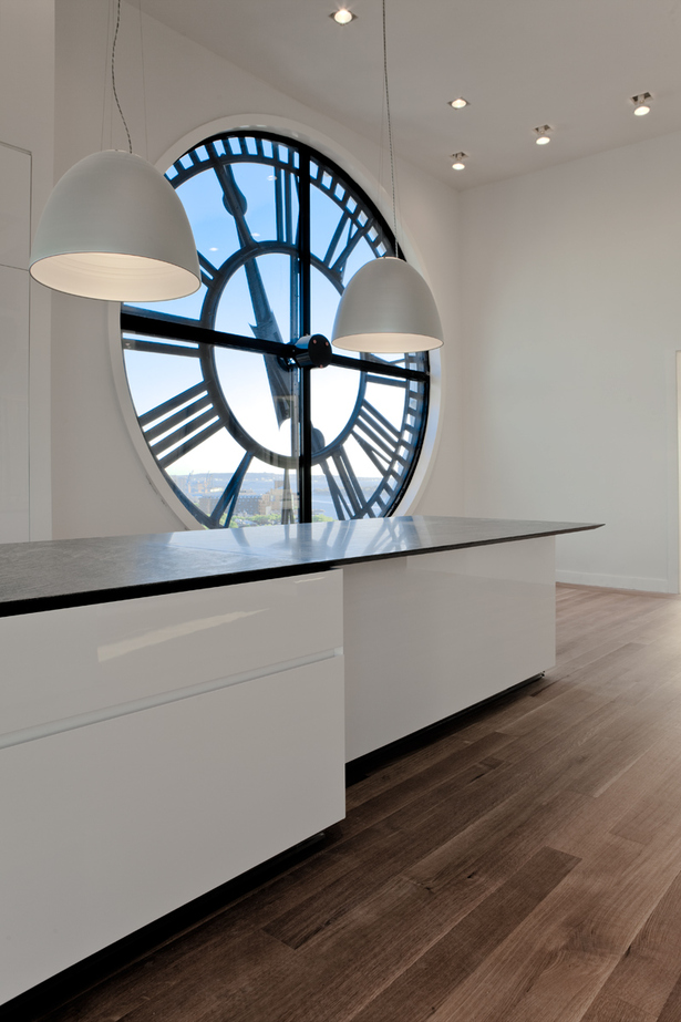 GLAM Kitchen - white lacquer cabinets with 45-degree edged and black melamine interiors and stainless steel drawers. The steel grill kick plates serve as air conditioning vents.