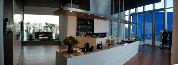 Doors: White Glossy lacquer, 22 mm (3/4”) thick with 30° top edge Sliding Counter: Thermo Oak with electronic movement (counter thickness 8cm = 3 1/8”) Counters: Hand crafted brushed stainless steel, 3 mm (1/8”) thick with soldered sinks and retractable faucet Hood: Custom by Minimal Open Shelving: Thin stainless steel shelving system 6mm (1/4”) thick with Thermo oak back panels