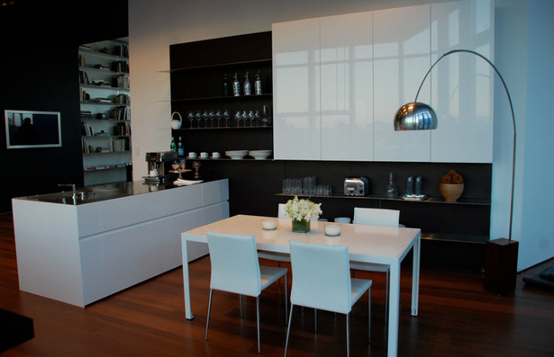 Doors: White Glossy lacquer, 22 mm (3/4”) thick with 30° top edge Sliding Counter: Thermo Oak with electronic movement (counter thickness 8cm = 3 1/8”) Counters: Hand crafted brushed stainless steel, 3 mm (1/8”) thick with soldered sinks and retractable faucet Hood: Custom by Minimal Open Shelving: Thin stainless steel shelving system 6mm (1/4”) thick with Thermo oak back panels