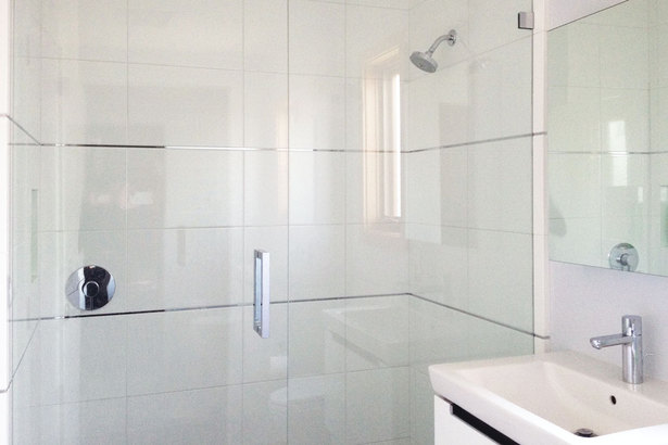 white tile, clean lines and chrome finishes in the bathrooms add a sense of openness