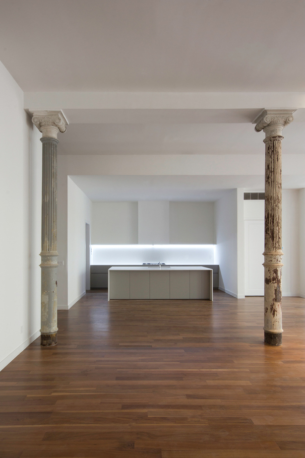 In the open space on the second floor, the minimalist design of the island in smooth matte gray Lacquer and CaesarStone quartz countertop, makes the island the focal point of the room.