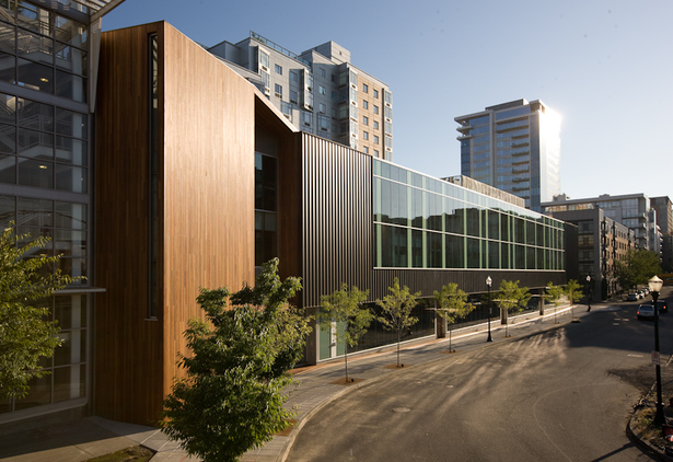 Metal panel & glass curtainwall box wrapped and supported with a Cumaru wood podium