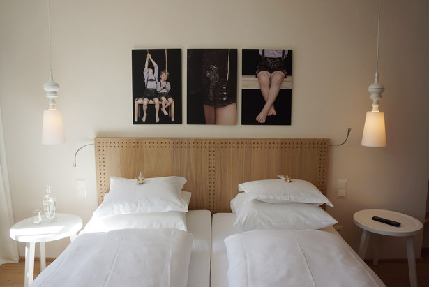 Traditional materials and light colors support the hotelier's personality and charme with different picture series presenting the whole family in each room. 