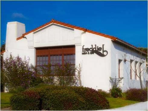 The building's Mission Revival style is charming from the street.