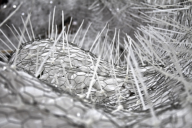 pressure-molded flowers attached to wire mesh via zip-ties