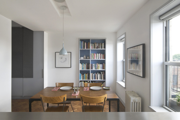 Bookshelves and a delicate chandelier echo the blue sky in their paint scheme 