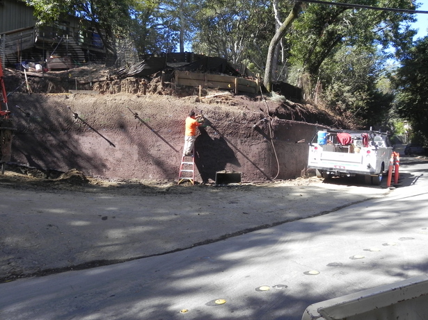 Wall cut with tieback rods and shotcrete backing in place. 