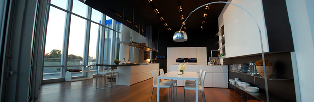 Doors: White Glossy lacquer, 22 mm (3/4”) thick with 30° top edge Sliding Counter: Thermo Oak with electronic movement (counter thickness 8cm = 3 1/8”) Counters: Hand crafted brushed stainless steel, 3 mm (1/8”) thick with soldered sinks and retractable faucet Hood: Custom by Minimal Open Shelving: Thin stainless steel shelving system 6mm (1/4”) thick with Thermo oak back panels