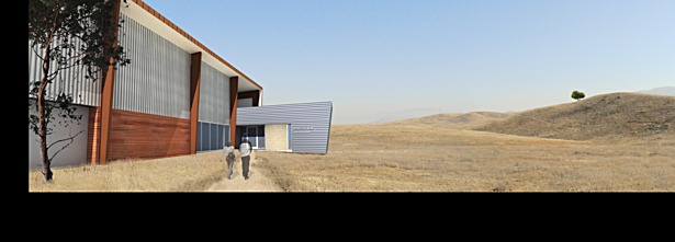 an operations hangar and visitor center lead to a path up into the hills and the overlook