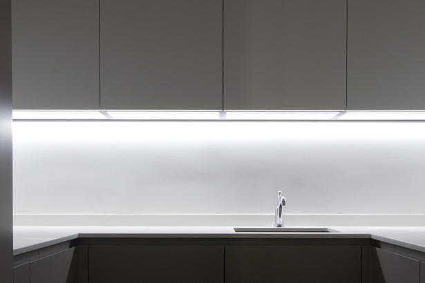 Hidden to the left is a small pantry of 6 square meters; despite its small dimension, the efficient design has made possible the inclusion of: refrigerator and freezer, microwave, oven, a secondary sink and more cabinets that enable the main kitchen to maintain its minimalist aesthetic and the clutter to be hidden away.