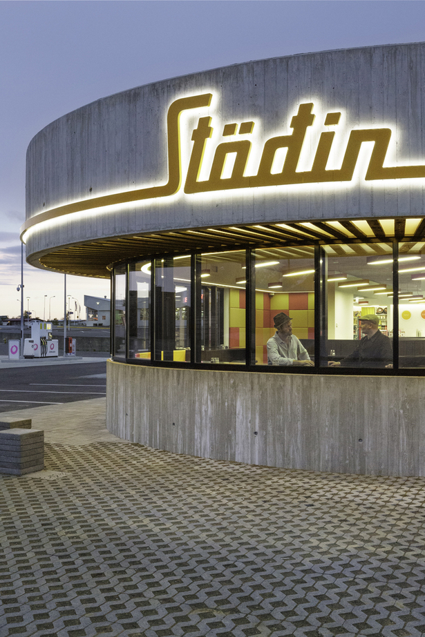 A backlit sign wraps around the entire building