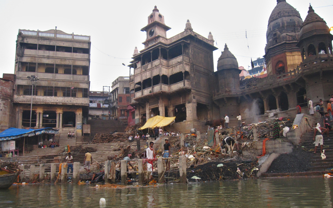Manikarnika Ghat, her pile of charcoal, blackened temple and two eternal waiting rooms