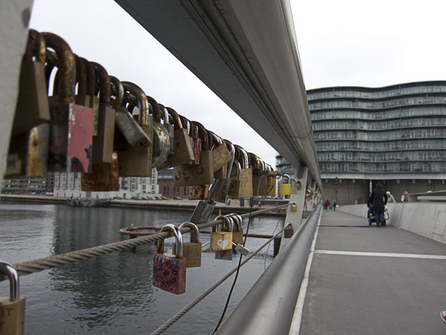 Padlocks, keylocks and combination locks string a bridge in Copenhagen