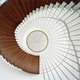 The suspended spiral stair as seen from below. The steps are made of solid bamboo material, and the entire structure is suspended from the ceiling with stainless steel rods. (Photo: Jussi Tiainen)