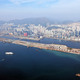 Aerial view of Kowloon East, former Kai Tak airport (foreground and left), Kowloon Bay (centre) and Kwun Tong district (right).