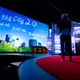 TED’s Amy Novogratz watches the video play onstage at TED2012 (Photo: James Duncan Davidson)