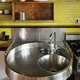 Her custom stainless steel kitchen sink, which is inset with a mixing bowl and bucket. Annie Schlechter