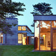 The Rifkind House in Wainscott, NY, a Long Island Modernist triptych pavilion clad in warm cedar siding, balanced with cool New York bluestone. Mahogany floor-to-ceiling window frames and custom-designed cherrywood furniture make the house an inviting and convivial entry into the pantheon of Modernist glass-walled houses. (Image via twbta.com)