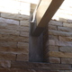 How the wooden beams meet the stone wall