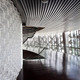 The glass brick wall in the main auditorium lake side lobby is made of 20.000 glass bricks with a wave pattern relating to the surrounding lake and to the curved bamboo block wall inside the auditorium. (Photo: Kari Palsila)