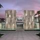 2012 Merit Award Winner: The KSCH Residence is a contemporary urban oasis in an established neighborhood in Bahrain. The austere, monolithic composition of the facade conceals dramatic, open spaces beyond. Rendering courtesy of Landry Design Group.