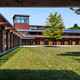 The Kohler Environmental Center as seen from the courtyard at Choate Rosemary Hall in Wallingford, Connecticut. To achieve net-zero energy use the building uses an array of tactics including natural ventilation and controlled use of daylight and shade. Solar panels have been installed on the roof and on an array behind the building. Photographer: Peter Aaron/Robert A. M. Stern Architects via Bloomberg 